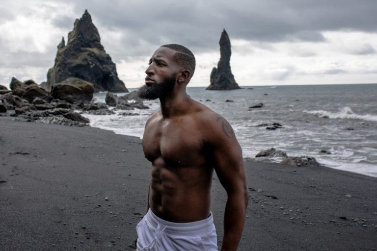 Portrait of young handsome man posing at the beach Stock Photo by halayalex