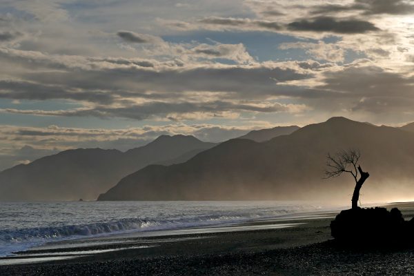 Beach clouds Coast mountains Ocean Sand sea shore sky Sunlight water Waves free photo CC0