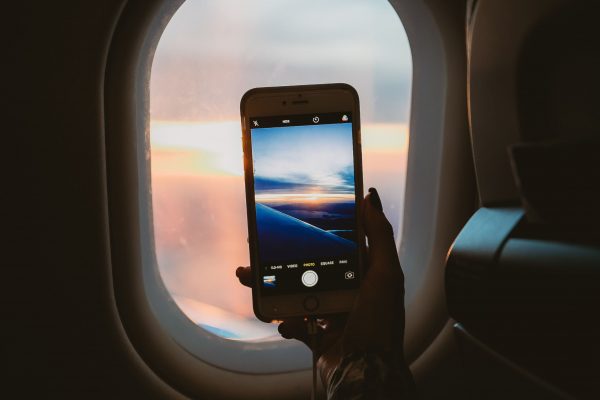 camera flight flying Hand iPhone Mobile Phone Picture Plane Seat sky sun travel Window wing wireless free photo CC0