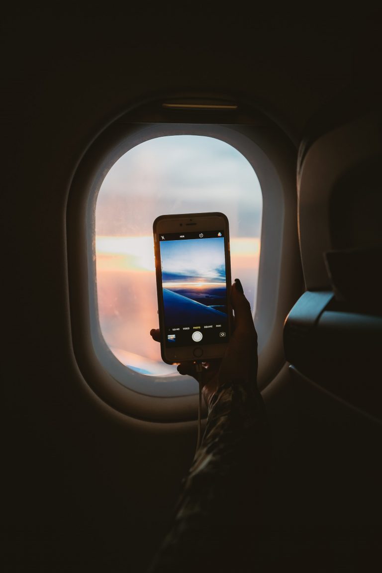 camera flight flying Hand iPhone Mobile Phone Picture Plane Seat sky sun travel Window wing wireless free photo CC0