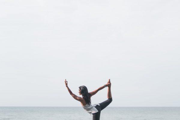 balance Concentration energy exercise female fit fitness Healthy lifestyle nature Ocean outdoors Person Pose rocks Seaside sky stretch water woman free photo CC0