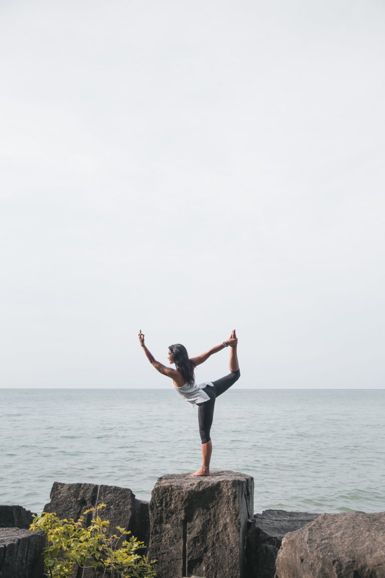 balance Concentration energy exercise female fit fitness Healthy lifestyle nature Ocean outdoors Person Pose rocks Seaside sky stretch water woman free photo CC0