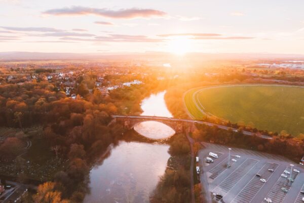 Aerial Background Bridge cars clouds Dawn Dusk field golden parking River road sky sunset travel View Warm free photo CC0