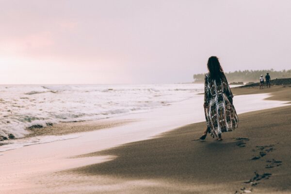 back Coast female footprints Ocean Person shore sky tide View walking water Waves free photo CC0