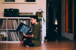picography-woman-sits-on-floor-looking-at-records