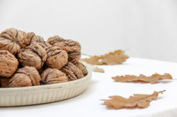 picography-plate-of-walnuts-near-oak-leaves