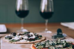 picography-two-large-pizzas-on-wooden-board-with-glasses-of-wine-nearby