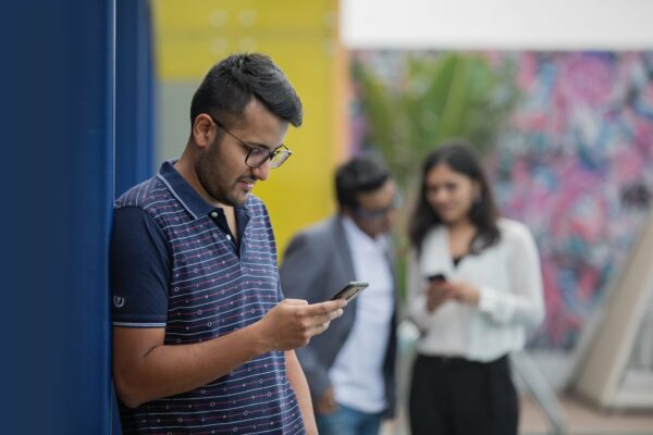 picography-young-man-against-wall-on-his-phone-600x400.jpg